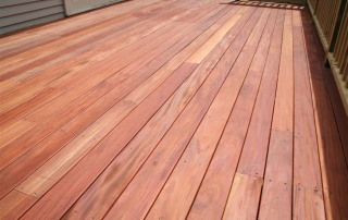 A beautifully installed Genuine Fijian Mahogany deck showcasing its rich, reddish-brown color, smooth grain, and premium hardwood quality, perfect for outdoor spaces.