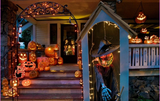 Halloween-themed mahogany deck with glowing jack-o'-lanterns, eerie lights, and spooky decorations creating a festive atmosphere.