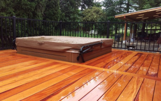 Stunning mahogany hardwood deck with a built-in hot tub, showcasing the rich color and weather-resistant durability of premium exotic wood. A perfect woodworking project for luxury backyard spaces and outdoor relaxation in Ontario, Canada.