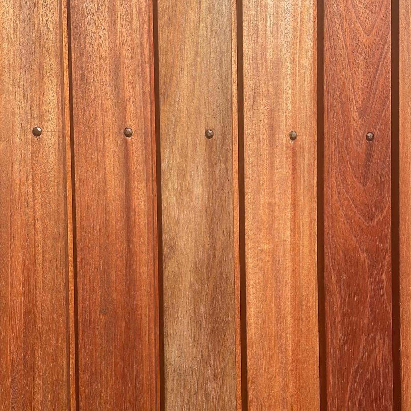 Detailed close-up of premium Fijian Mahogany hardwood siding, showcasing its rich natural grain, warm tones, and durable construction. This sustainable wood siding is perfect for modern home exteriors, providing longevity and elegance in Ontario, Canada.