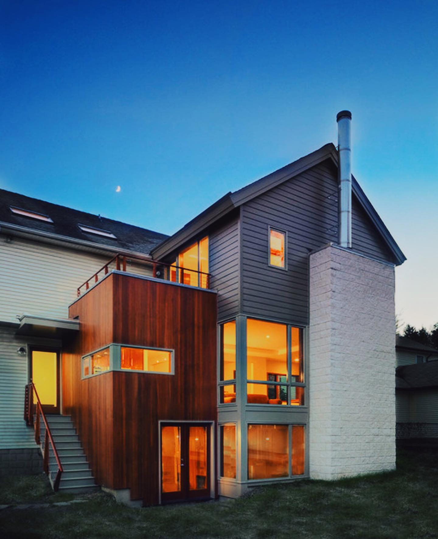 Modern Home Exterior with Mahogany Wood Siding Contemporary house featuring rich Mahogany hardwood siding, blending natural warmth with modern design. This premium wood siding enhances curb appeal while offering durability and weather resistance, perfect for stylish home exteriors in Ontario, Canada.