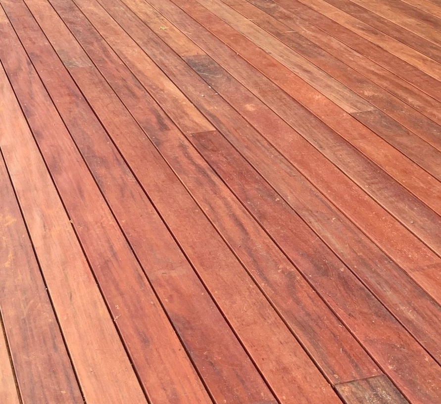 Close-up of a Fijian Mahogany hardwood deck, showcasing its rich reddish-brown tones, durability, and smooth finish, ideal for premium outdoor decking.